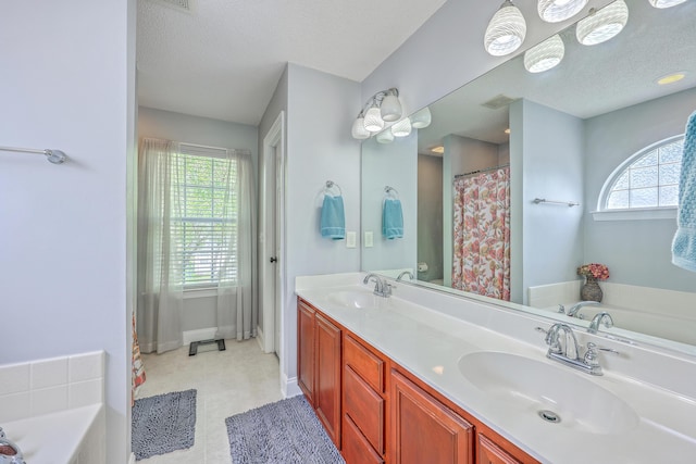 111 Kapalua Run, Summerville, SC 29483 - full bathroom with a garden tub, double vanity, a textured ceiling, a shower with shower curtain, and baseboards