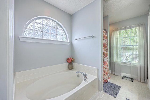 111 Kapalua Run, Summerville, SC 29483 - full bathroom featuring a textured ceiling, plenty of natural light, a garden tub, baseboards, and curtained shower