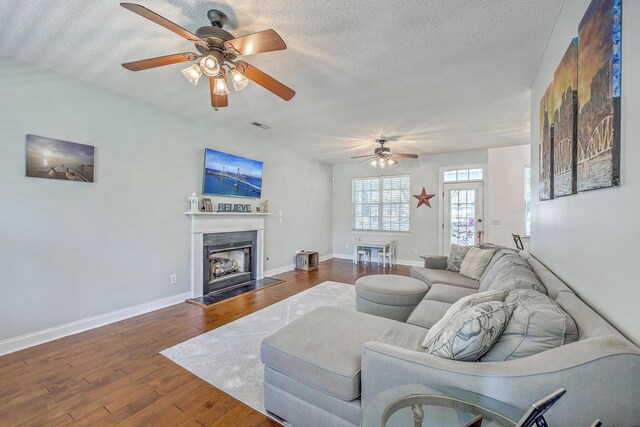 111 Kapalua Run, Summerville, SC 29483 - living room with ceiling fan, a textured ceiling, wood finished floors, baseboards, and a fireplace with raised hearth