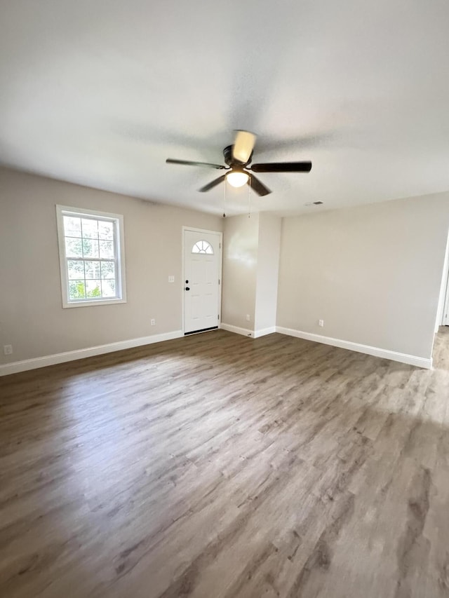 710 Gadsden Loop, Walterboro, SC 29488 - unfurnished living room featuring wood finished floors, a ceiling fan, and baseboards