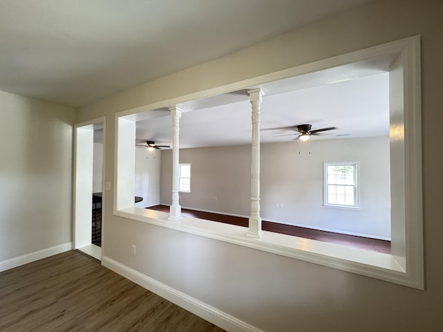 710 Gadsden Loop, Walterboro, SC 29488 - unfurnished room with ceiling fan, wood finished floors, baseboards, and ornate columns