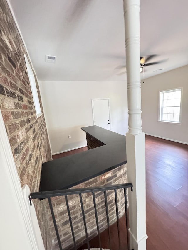 710 Gadsden Loop, Walterboro, SC 29488 - stairway featuring brick wall, wood finished floors, ceiling fan, and baseboards
