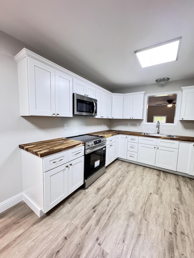 710 Gadsden Loop, Walterboro, SC 29488 - kitchen with stainless steel appliances, a sink, light wood finished floors, and butcher block counters