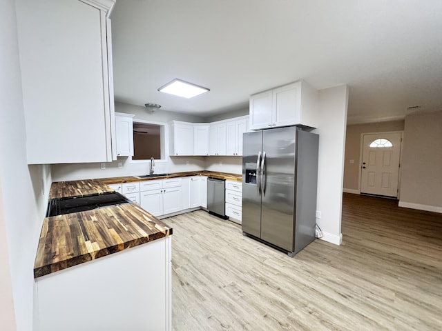 710 Gadsden Loop, Walterboro, SC 29488 - kitchen with stainless steel refrigerator with ice dispenser, a sink, stove, wooden counters, and light wood-style flooring