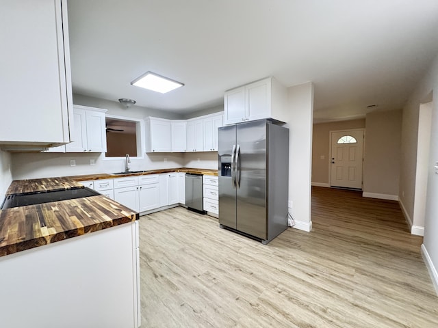 710 Gadsden Loop, Walterboro, SC 29488 - kitchen featuring stainless steel fridge with ice dispenser, butcher block countertops, light wood-style floors, baseboards, and white cabinetry