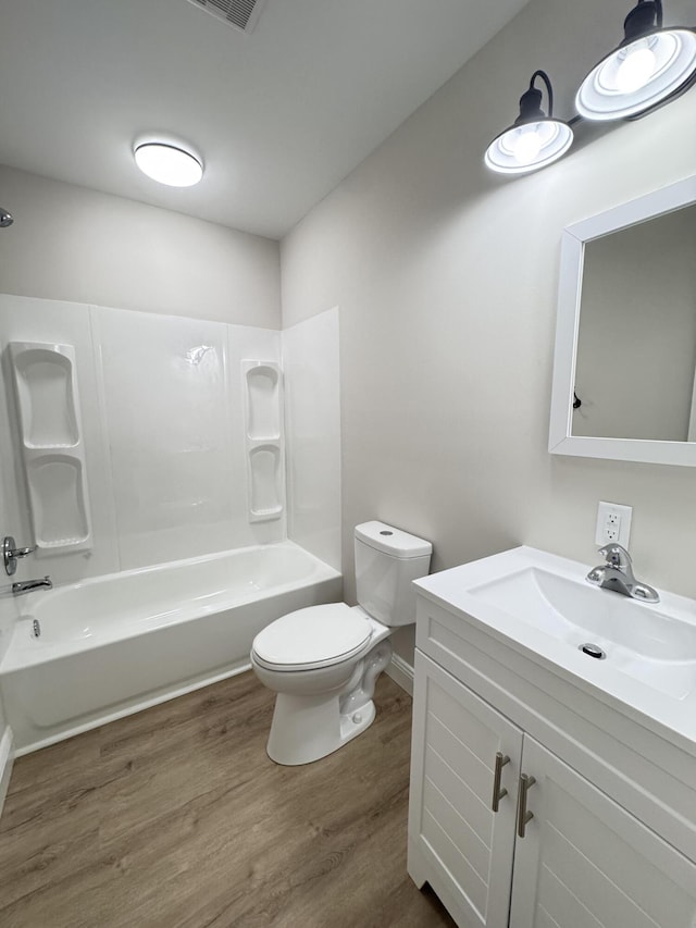 710 Gadsden Loop, Walterboro, SC 29488 - bathroom with vanity, toilet, wood finished floors, shower / bathtub combination, and baseboards