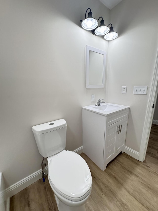 710 Gadsden Loop, Walterboro, SC 29488 - bathroom with wood finished floors, vanity, toilet, and baseboards