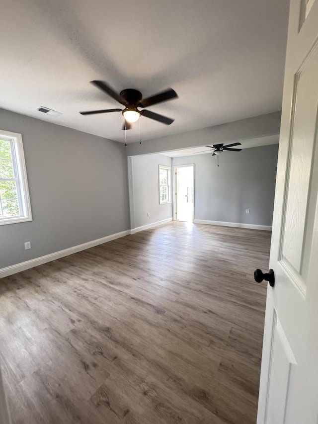 710 Gadsden Loop, Walterboro, SC 29488 - unfurnished room featuring plenty of natural light, ceiling fan, wood finished floors, and baseboards