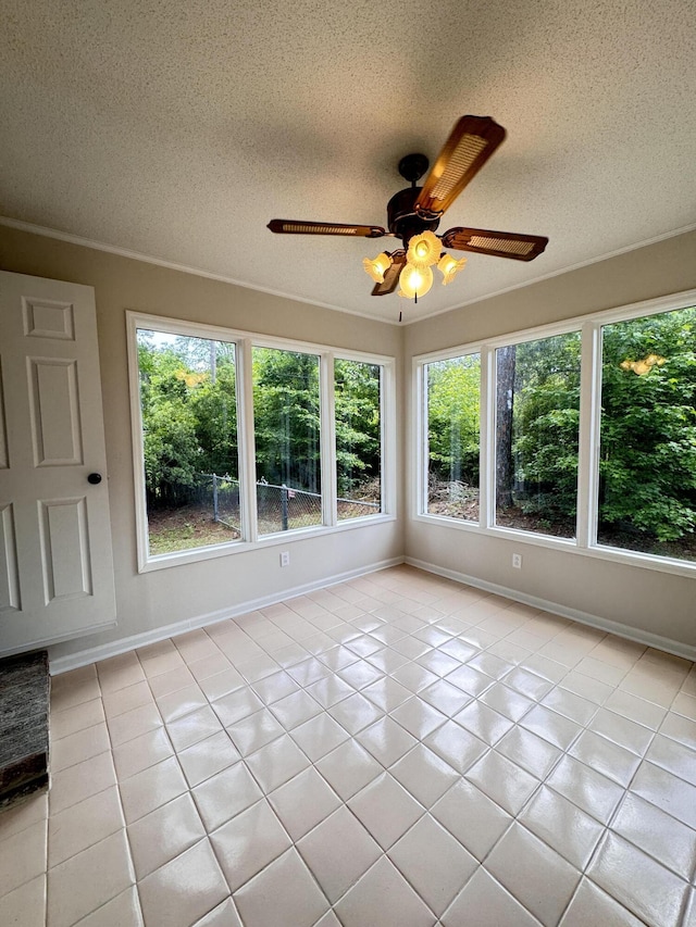 710 Gadsden Loop, Walterboro, SC 29488 - unfurnished sunroom featuring plenty of natural light, a textured ceiling, tile patterned floors, and baseboards