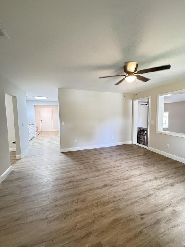 710 Gadsden Loop, Walterboro, SC 29488 - unfurnished living room with a ceiling fan, wood finished floors, and baseboards