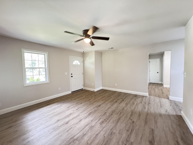 710 Gadsden Loop, Walterboro, SC 29488 - unfurnished living room featuring ceiling fan, wood finished floors, and baseboards