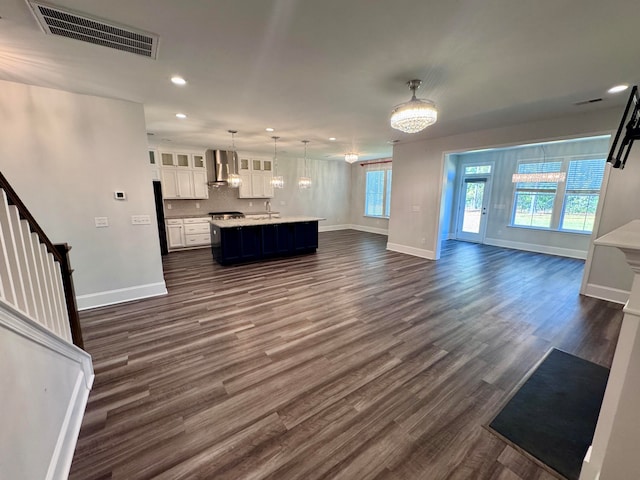 unfurnished living room featuring dark hardwood / wood-style floors and sink