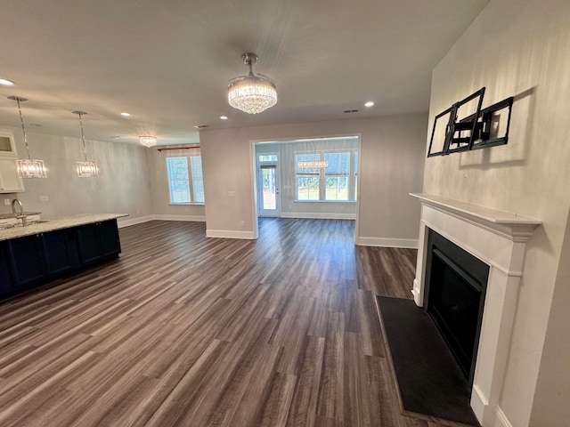 unfurnished living room with sink and dark hardwood / wood-style flooring