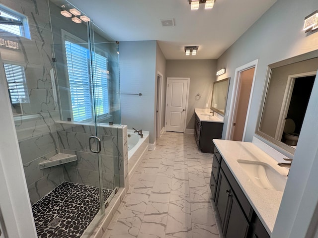 bathroom with vanity, independent shower and bath, and a healthy amount of sunlight