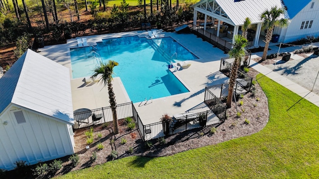 view of pool featuring a yard and a patio