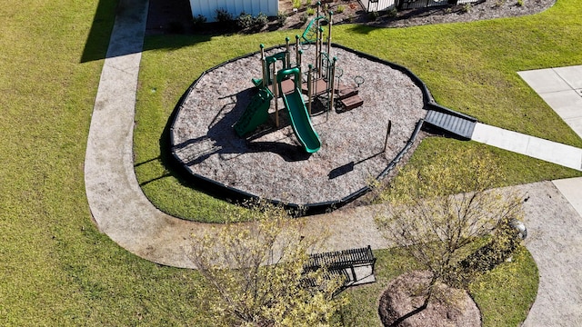 view of home's community with a playground and a lawn