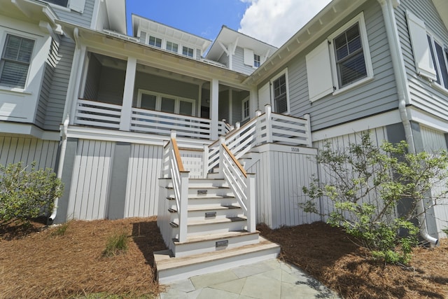 rear view of house featuring stairway