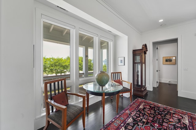 interior space featuring visible vents, dark wood finished floors, baseboards, ornamental molding, and recessed lighting