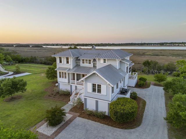 birds eye view of property with a water view