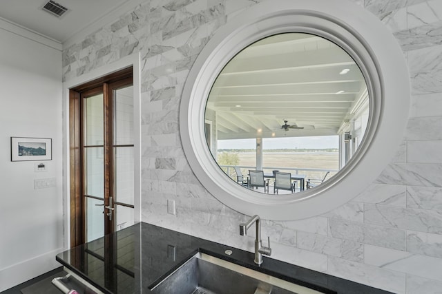 bathroom with visible vents, a sink, ceiling fan, and french doors
