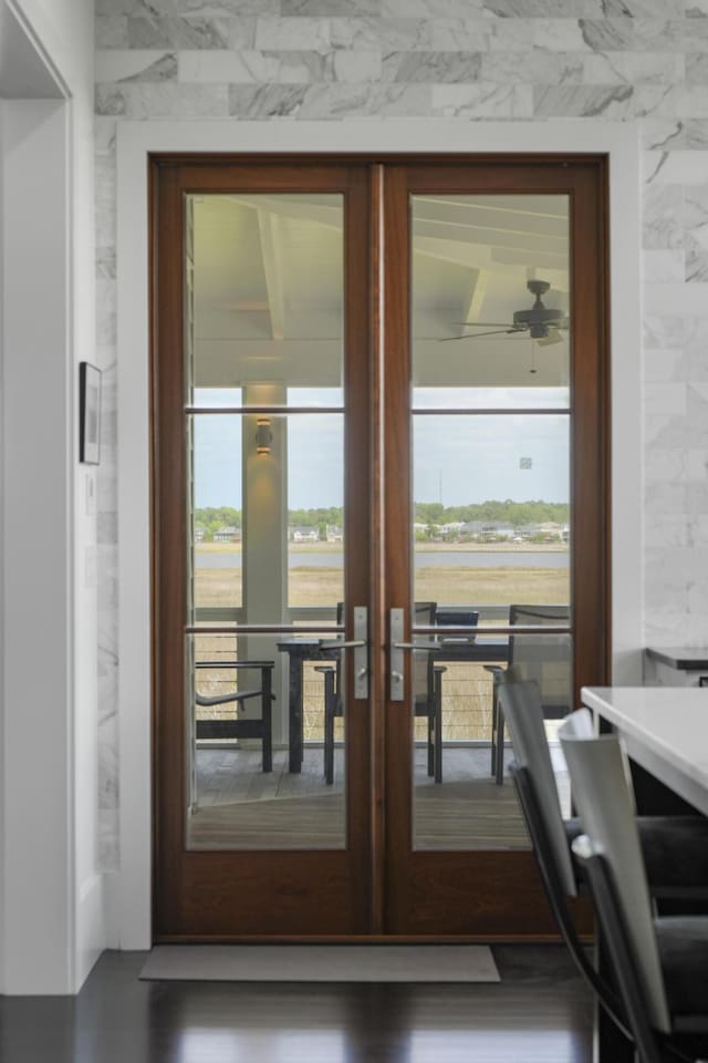 doorway to outside featuring a ceiling fan and french doors