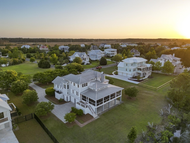 aerial view at dusk featuring a residential view
