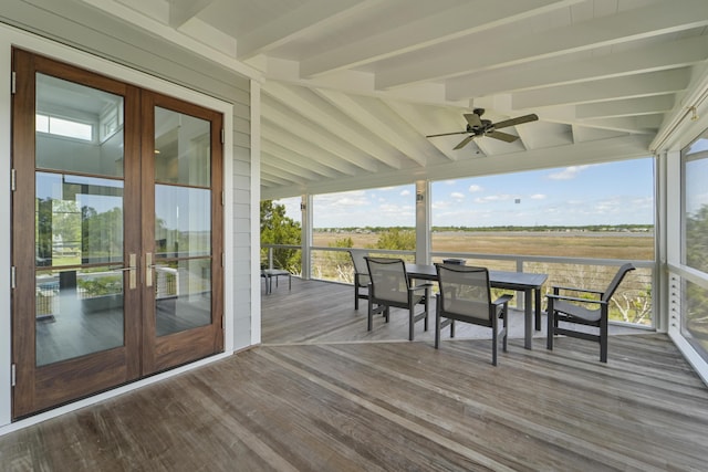 wooden deck with french doors, a ceiling fan, and outdoor dining space