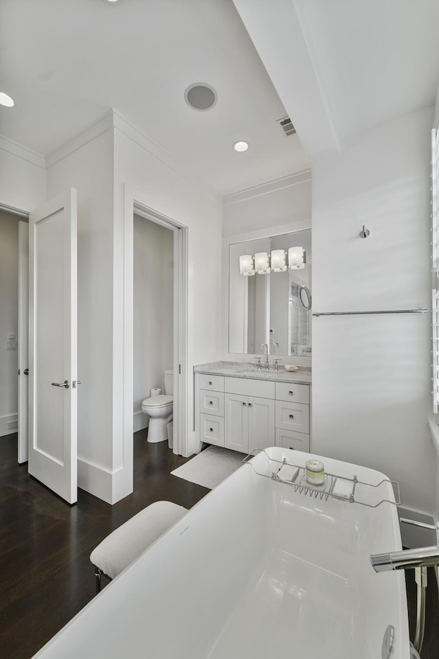 bathroom featuring crown molding, toilet, recessed lighting, wood finished floors, and visible vents