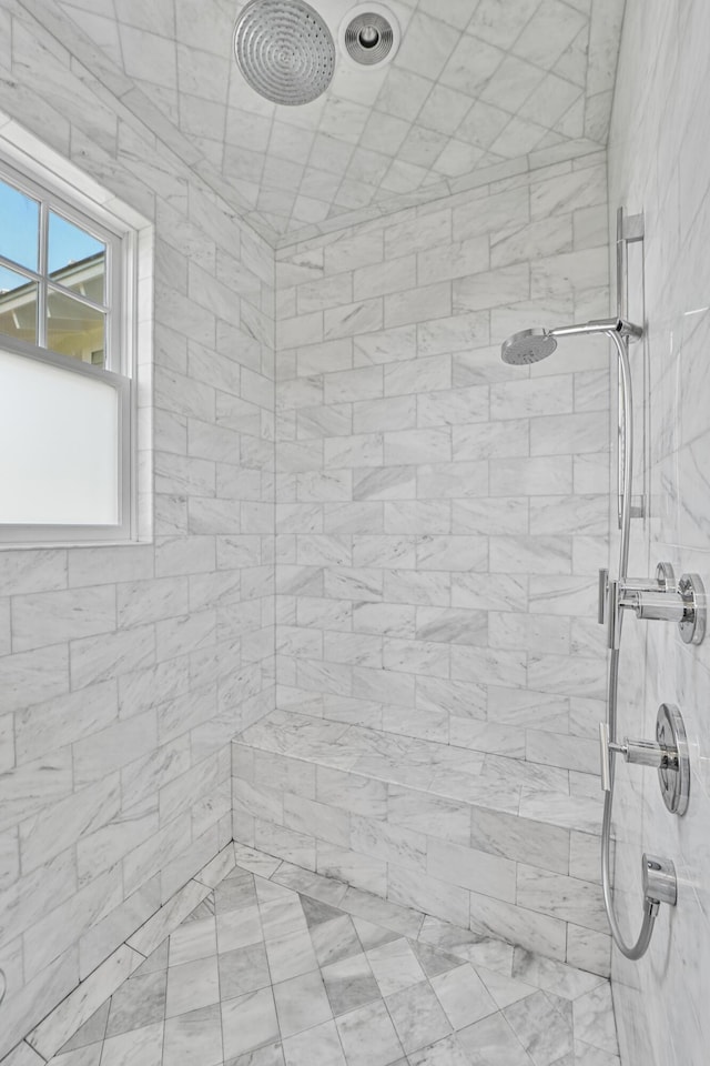 interior details with a tile shower