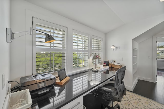 office featuring baseboards, vaulted ceiling, and wood finished floors