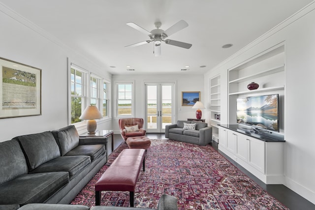 living area with a healthy amount of sunlight, a ceiling fan, french doors, and built in shelves