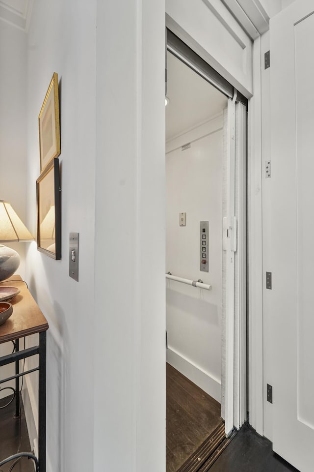 hall featuring baseboards