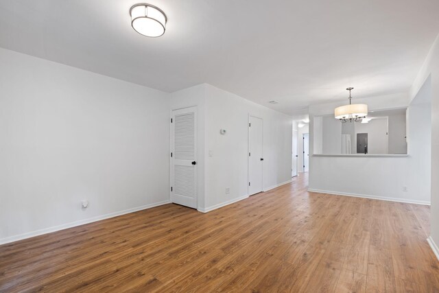 1530 Fort Johnson Rd Unit 2E, Charleston, SC 29412 - unfurnished living room with wood finished floors and a chandelier