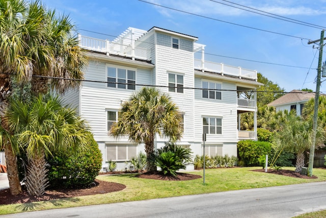 7 33rd Ave, Isle Of Palms, SC 29451 - view of front of house with a balcony and a front lawn
