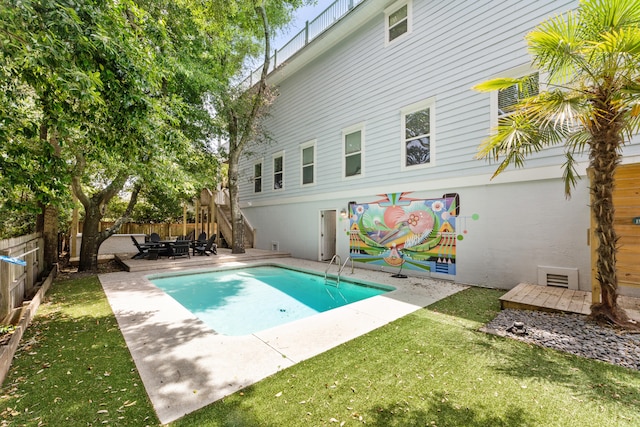 view of pool featuring a patio area and a lawn