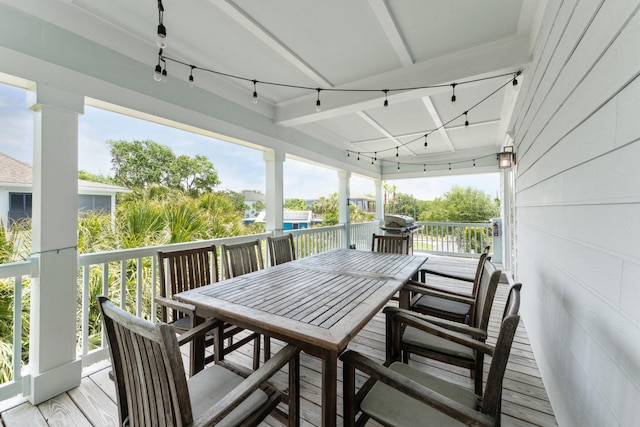 sunroom featuring plenty of natural light and rail lighting