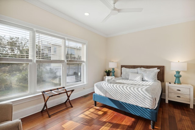 bedroom featuring ceiling fan, dark wood-type flooring, and multiple windows