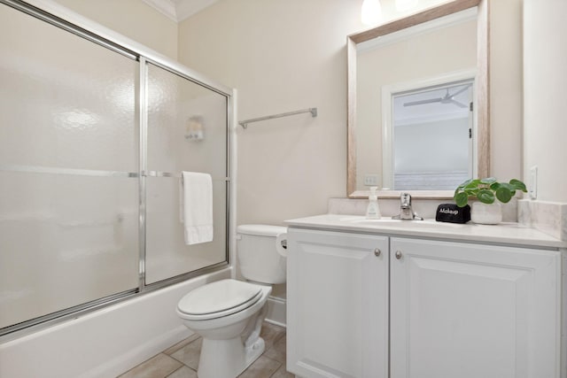 full bathroom featuring toilet, crown molding, tile floors, shower / bath combination with glass door, and vanity