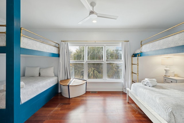 bedroom featuring ceiling fan, dark wood-type flooring, and ornamental molding