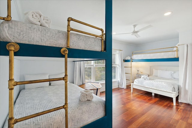 bedroom with ceiling fan, ornamental molding, and dark hardwood / wood-style floors