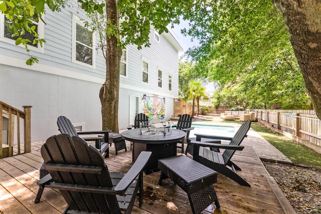 wooden deck with a fenced in pool