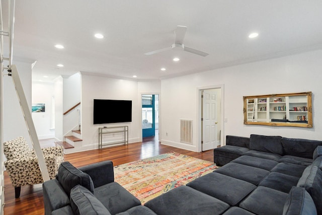 living room with ceiling fan, crown molding, and dark hardwood / wood-style floors