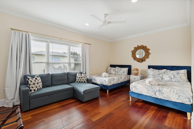 bedroom with ceiling fan, dark wood-type flooring, and ornamental molding