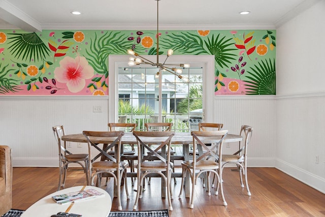 dining area featuring a notable chandelier, crown molding, and wood-type flooring