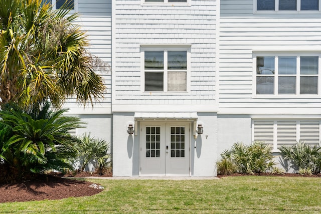 doorway to property featuring a yard