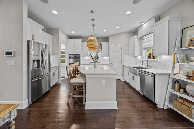 255 Saxony Loop, Summerville, SC 29486 - kitchen with appliances with stainless steel finishes, a sink, a kitchen island, light countertops, and tasteful backsplash