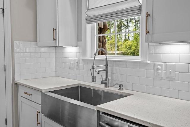 255 Saxony Loop, Summerville, SC 29486 - kitchen featuring a sink, backsplash, white cabinets, light stone countertops, and stainless steel dishwasher