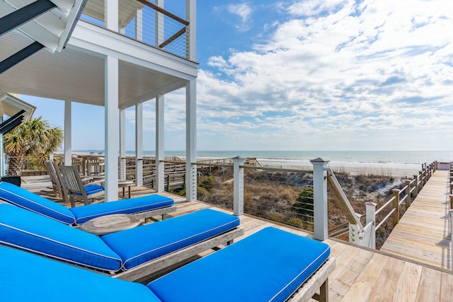 view of patio / terrace featuring a water view and a view of the beach