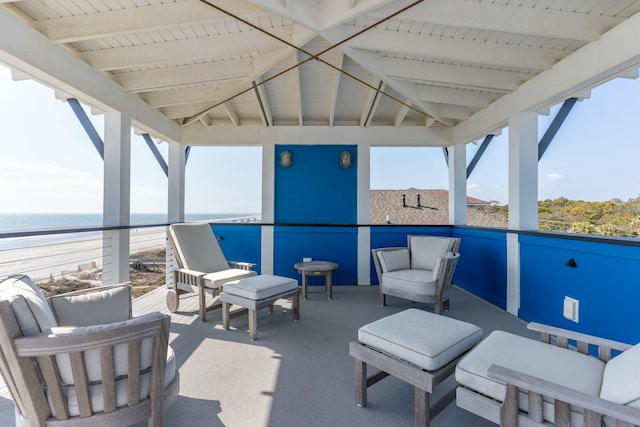 view of patio with a water view and a balcony