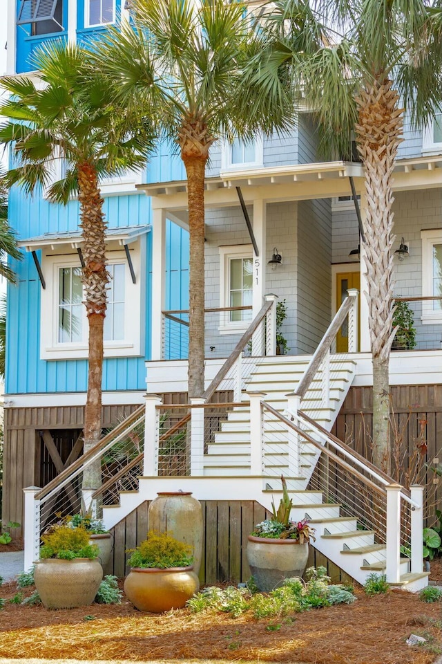 view of front of home with stairs and covered porch